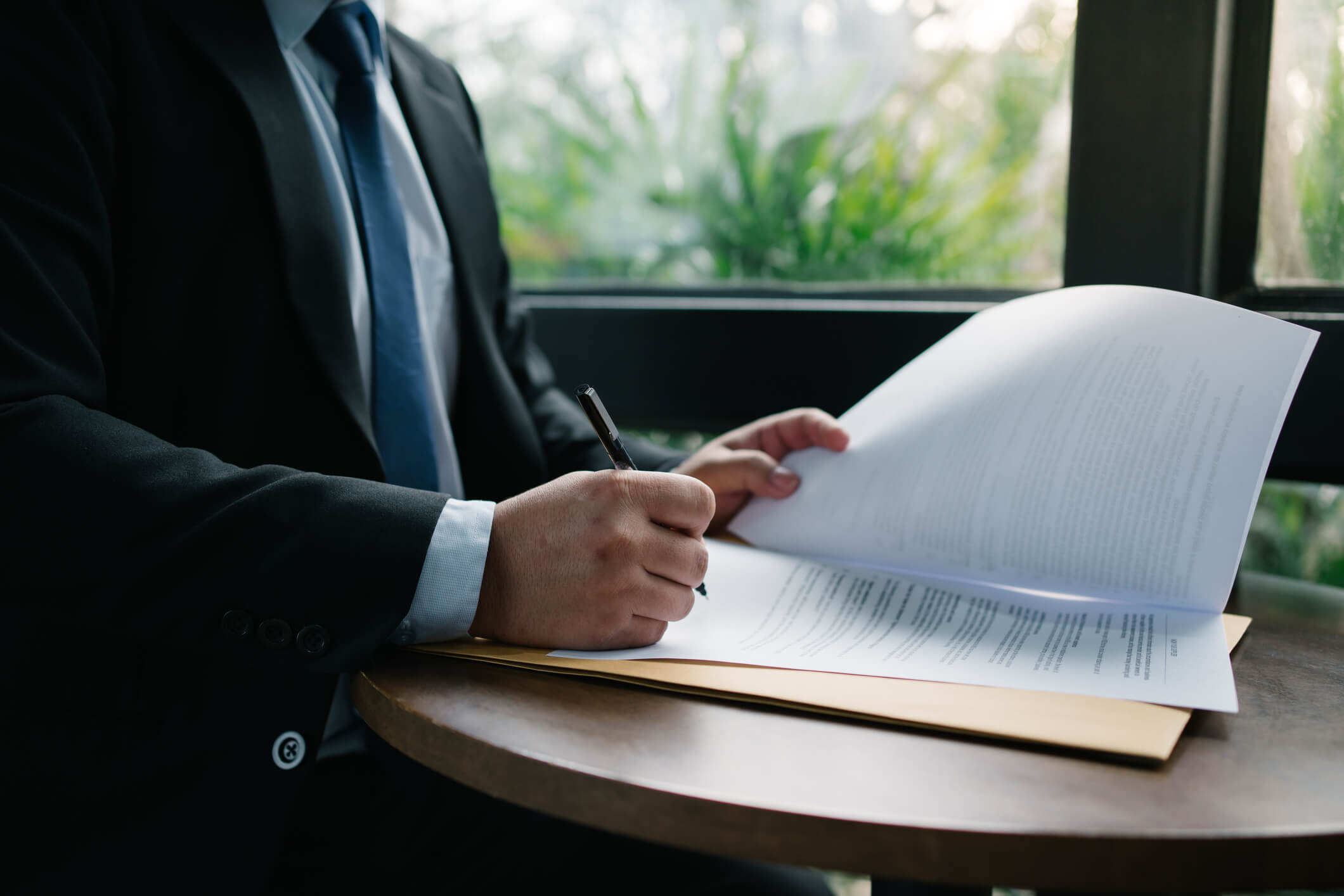 Businessman signing documents at a table